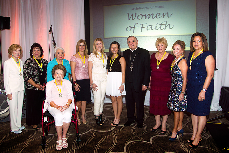 Archbishop Thomas Wenski, center, poses with the 10 outstanding women from across the archdiocese who were honored for their work, dedication and commitment to the Catholic Church with the first ever “Women of Faith” awards luncheon, held Oct. 26 at Turnberry Isle Hotel in Aventura. Proceeds from the event will support Catholic education locally. From left: Winifred Amaturo, Sally Russomanno, Barbara Romani, Marie Ludwick (seated), Ada Armas, Marile Lopez, Christina Wells, Carol Ann Coyle, Swanee DiMare and Jacqueline De Souza.
