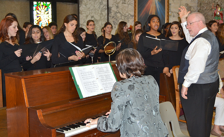The St. Thomas Aquinas High School Choir/Chorale sings at the ThanksForGiving Mass, on Nov. 16 at St. Clement Church, in Broward. Conducting was the school's theology instructor, Michael McCormack, with choral director Wanda Drozdovitch on piano.