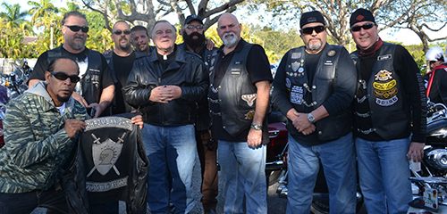 Archbishop Thomas Wenski poses with members of the Chrome Knights Motorcycle Association, including the group's president and founder, Rene John Sardinas (next to archbishop at right).