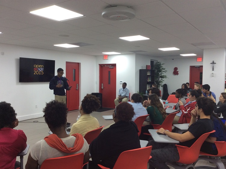 Senior Malik Mackey reads a spoken word poem at the Msgr. Pace High Literary Guild's annual Open Mic Night inside the school's Innovation Center.