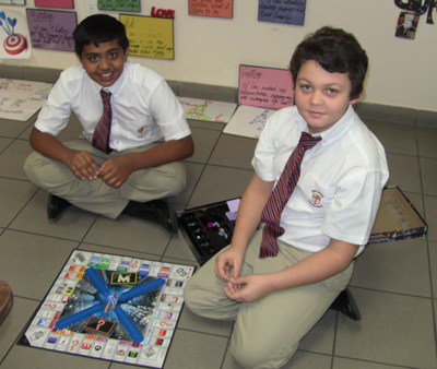 With the opportunity to buy McDonald's, Sony, Coca-Cola and other big-named brands, Adam John and Ronald Stock could not wait to play Monopoly Empire. Adam and Ronald, along with other St. Andrew School students, joined in the fun of playing non-electronic games as a part of Global Challenge Game Day.
