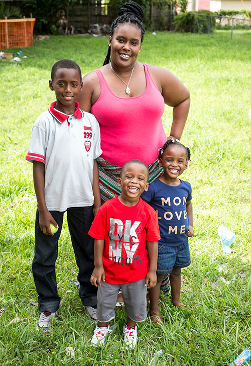 Photographer: TOM TRACY | FC Kiondra Ross, recipient of the Pope Francis Habitat for Humanity home in Liberty City, visits the future site of her residence, along with her sons Daniel (left) and Kaydan, and daughter Kayla. The project is supported by a $ 60,000 donation from the Archdiocese of Miami that matches a grant made by an anonymous donor.