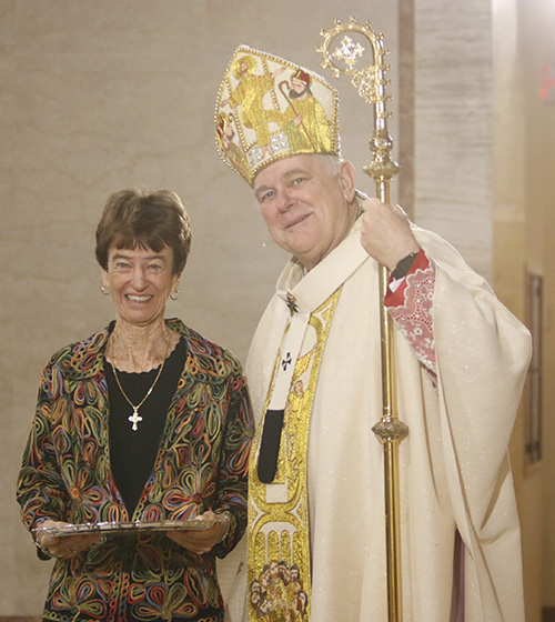 Cecile McAlpin of St. Andrew Parish in Coral Springs receives her One in Charity award from Archbishop Thomas Wenski.