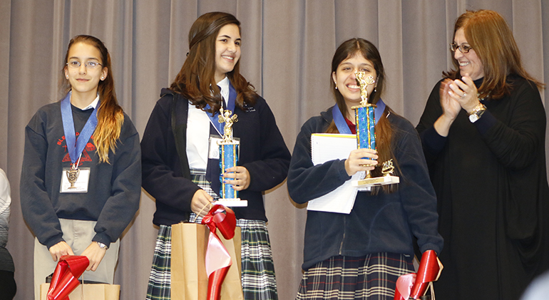 Blessed Trinity School Principal Maria Teresa Perez poses with the Spanish Spelling Bee winners, from left: Alana Batista, an eighth-grader at Blessed Trinity, and third place finisher; Annabella Bozo-Cabrera, an eighth-grader from St. Theresa School in Coral Gables, and second place finisher; and winner Andrea Schroeder, a seventh-grader at St. Andrew School in Coral Springs.