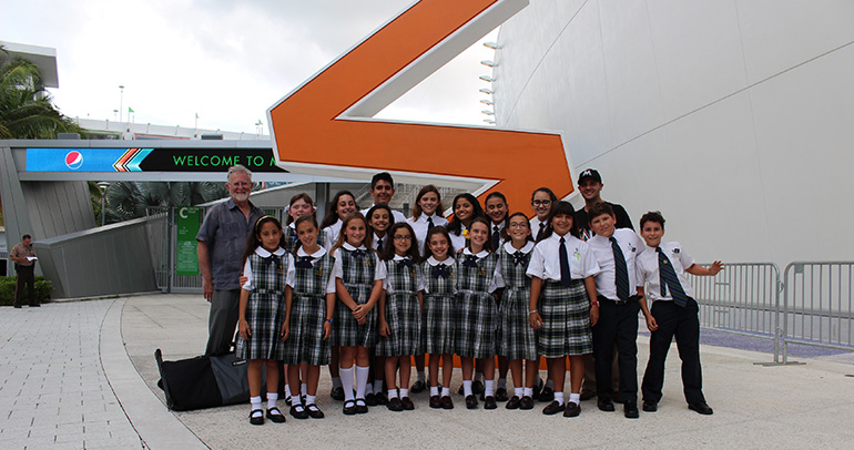 Members of the Church of the Little Flower/St. Theresa School Honor Choir pose outside Marlins Park with Jorge Santibañez, right rear, parish director of religious education, and Roger Mason, left rear, choir director.