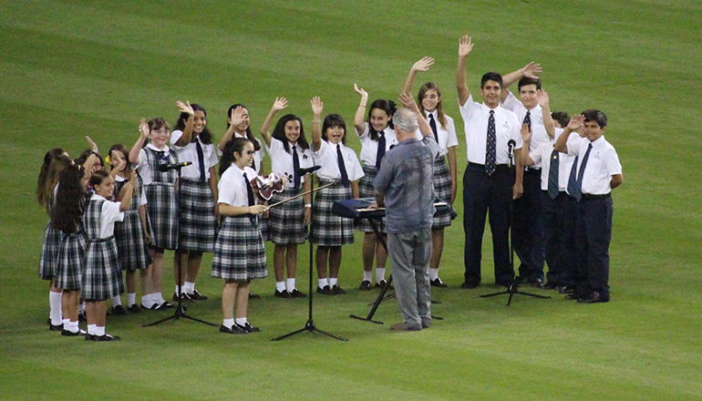 Members of the Church of the Little Flower/St. Theresa School Honor Choir wave after singing the national anthem Aug. 26 at Marlins Park, before a game between the Miami Marlins and the San Diego Padres.