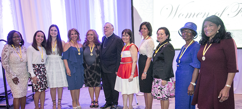 The 2016 Women of Faith honorees pose for a group photo with Archbishop Thomas Wenski, from left: Solange Joseph (faith), Jennifer Mendez (love), Sandra Cardenal (youth), Sonnia Viyella (radiance), Norma Jean Abraham (charity), Cari Canino (wisdom), Natalie Bauta (motherhood), Maria Cristina Diaz (compassion), Lona Matthews (grace) and Dina Mitjans (humility).