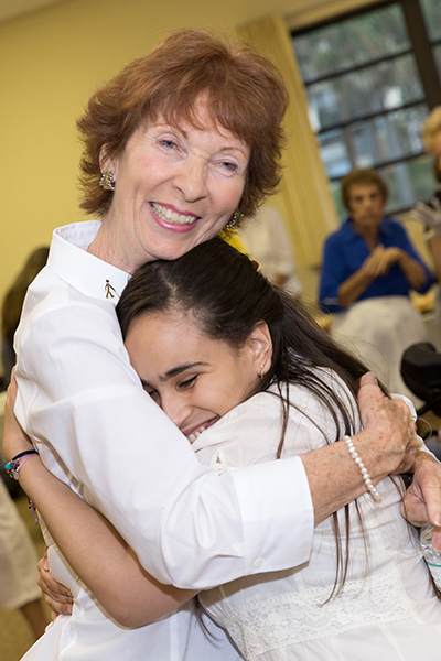 Dolores Hanley McDiarmid, left, a Catholic lay minister and one of the main organizers of the annual Mass and reception for persons with disabilities in Broward, hugs Doris Mancebo of St. Vincent Parish in Margate. This year's Mass and reception took place Nov. 19 at St. Gabriel Church in Pompano Beach.