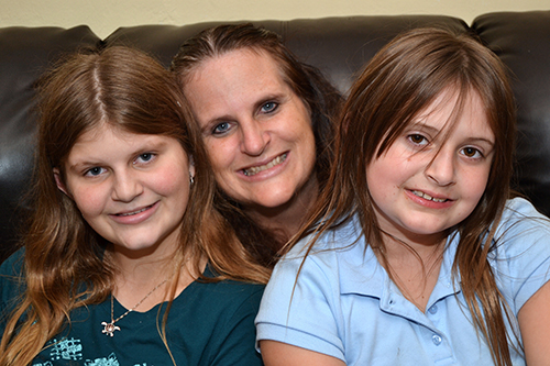 Kimberly Eisenmann-Byerly of Plantation, with her children Daley, 13, left, and Kailey, 7. Both children have gone to Camp Erin, a bereavement camp run by Catholic Hospice, a ministry of the archdiocese.