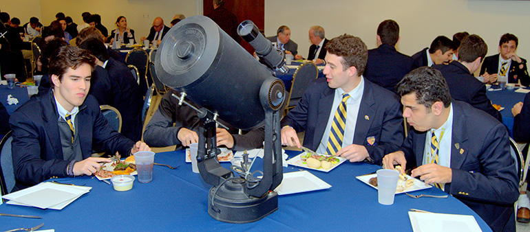 A small telescope was among the table centerpieces for a luncheon at the Belen Jesuit Preparatory School during a visit by Brother Guy Joseph Consolmagno, director of the Vatican Observatory.
