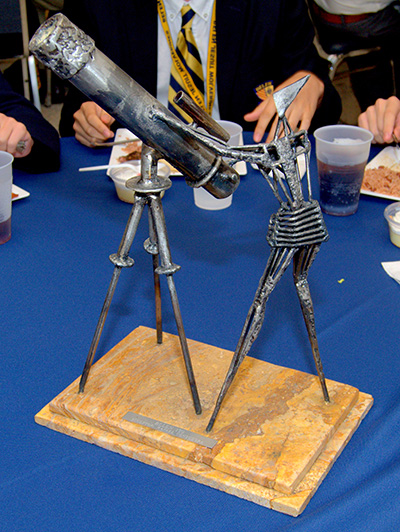 A metal sculpture of an astronomer was among the table centerpieces for a luncheon at the Belen Jesuit Preparatory School during a visit by Brother Guy Joseph Consolmagno, director of the Vatican Observatory. The sculpture was made by Belen alumnus Rafael Consuegra.