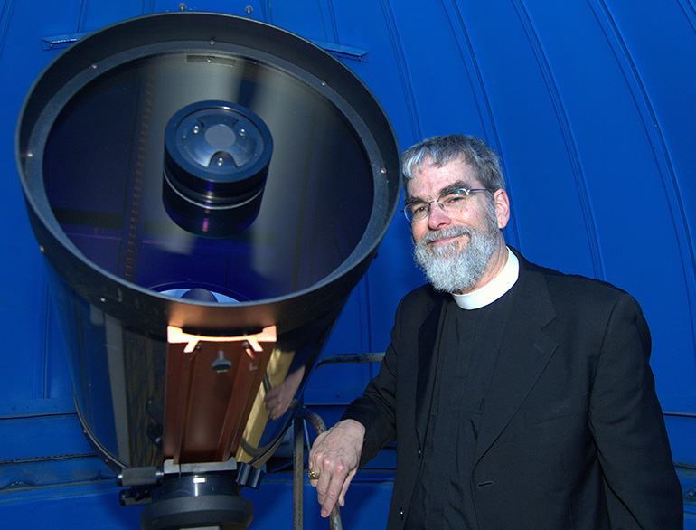 Brother Guy Joseph Consolmagno, director of the Vatican Observatory, poses with the 16-inch telescope of Belen Jesuit Preparatory School.