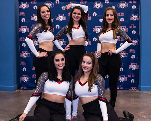 Victoria Molina, standing at center, poses with her St. Thomas University dance teammates. She gave up being the team co-captain because of the time she needed to be away for Irish step dancing competitions.