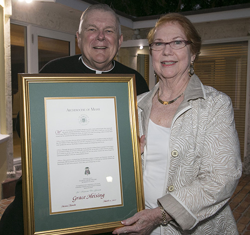 Archbishop Thomas Wenski inducts Grace Heising of St. Joseph Parish, Miami Beach, into the A.M.D.G. (Ad Majorem Dei Gloriam) Society, recognizing those who have donated ,000 or more to the ABCD drive for five consecutive years.