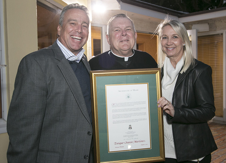 Archbishop Thomas Wenski inducts Henry and Jeanne Martinez, of St. Louis Parish in Pinecrest, into the A.M.D.G. (Ad Majorem Dei Gloriam) Society, recognizing those who have donated ,000 or more to the ABCD drive for five consecutive years.