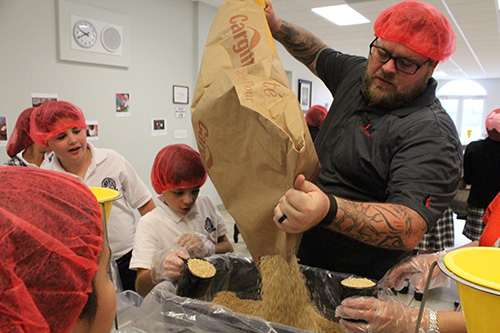Make way for the protein: Jason Haulbrook refills a box of dried soy flour that will be mixed into the meal bags.