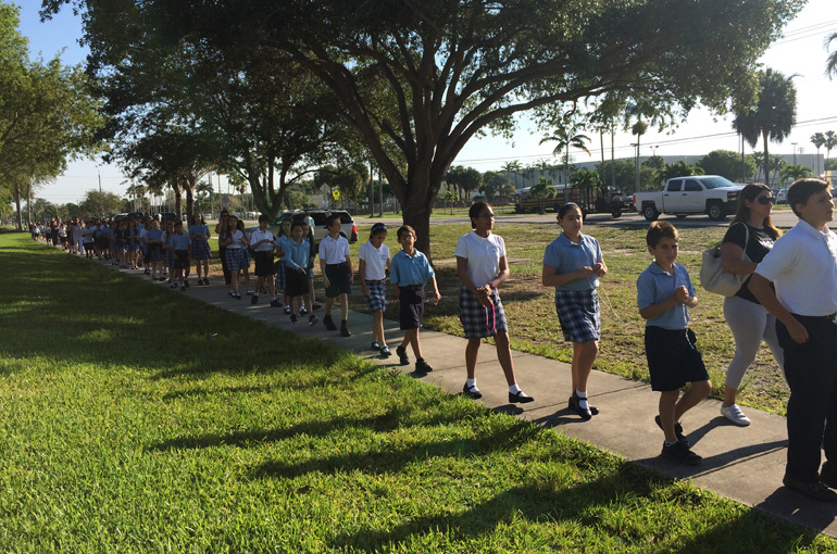 Students from St. Bonaventure School walk and pray during a procession in honor of the Virgin Mary.