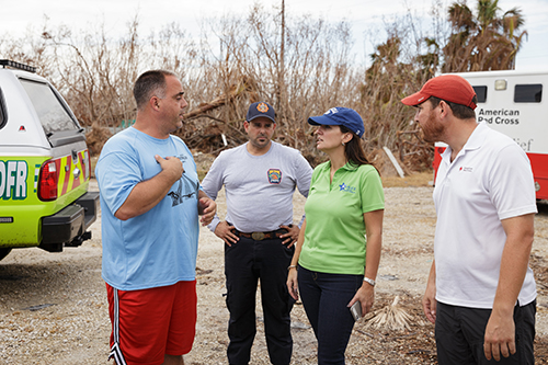 State Rep. Jeanette Nunez, a Miami Republican who chairs the House Select Committee on Hurricane Response and Preparedness in Florida, speaks with American Red Cross staff adjacent to the grounds of the Miami archdiocesan church most devastated by Hurricane Irma, St. Peter the Fisherman in Big Pine Key.