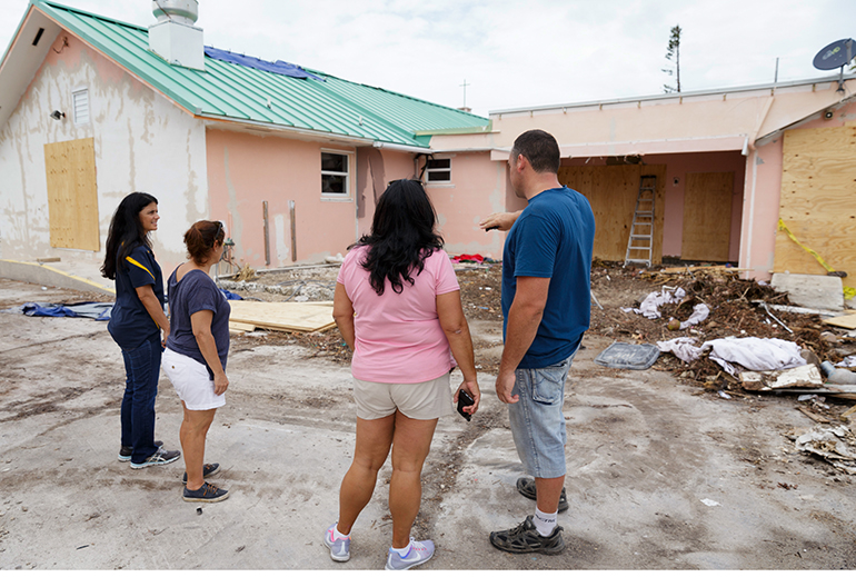 Volunteers from parishes throughout the Archdiocese of Miami inspect the grounds at the archdiocesan church most devastated by Hurricane Irma, St. Peter the Fisherman in Big Pine Key. The church has been deemed unusable and is expected to be rebuilt.