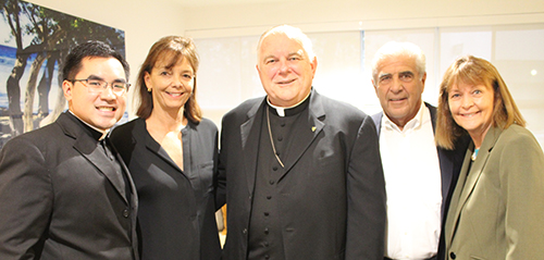 Supporters of the UCatholic Campus Ministry gathered in the new student suite in Pentland House at the University of Miami. In the photo, from left, is Father Phillip Tran, chaplain at UM, Amy Easton, Archbishop Thomas Wenski, Edward Easton and Pat Whitely, vice president of Student Affairs at UM.