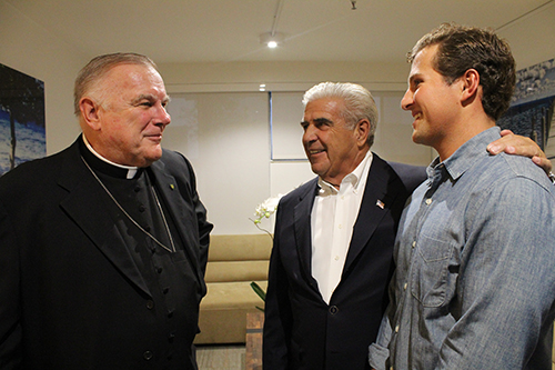 Edward Easton, the initial donor to the UM Catholic campus ministry, introduces his grandson CJ Easton to Archbishop Thomas Wenski.