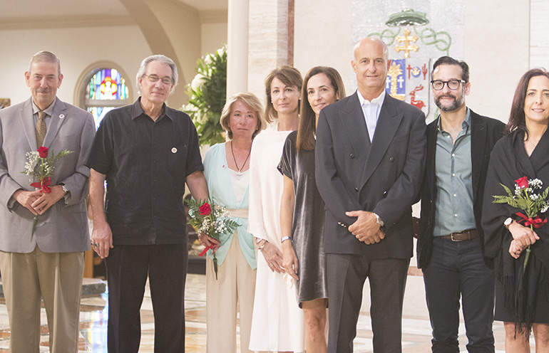 Those inducted into the Archbishop Coleman Carroll Legacy Society, for remembering the Church in their will, pose for a photo after receiving a rose from Archbishop Thomas Wenski. The rose recalls the words of St. Therese of the Little Flower, who said she wanted to spend her eternity in heaven doing good works on earth.