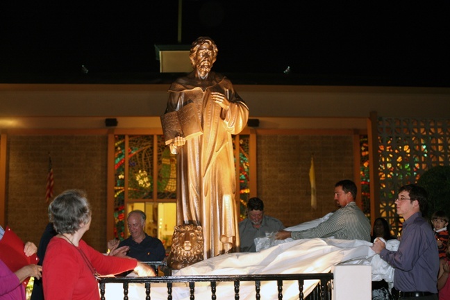 Parishioners unveil the newly-bronzed statue of St. Jerome.