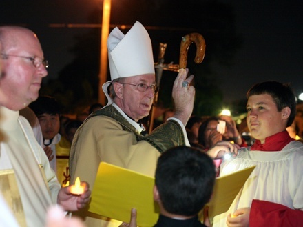 Bishop John Noonan blesses the newly-bronzed St. Jerome statue as Father Michael Davis, parochial administrator, looks on at left.