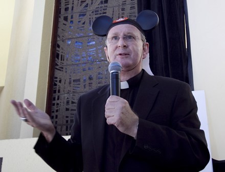 Payback for a prankster: Bishop Noonan wears his Mickey miter during the farewell lunch and roast thrown by Pastoral Center employees.