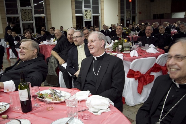 Bishop Noonan sits between Archbishop Wenski, left, and Bishop Estevez during the roast that followed the vespers service at St. John Vianney College Seminary.