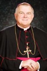 Archbishop Thomas Wenski, betting Key lime pie, Fort Lauderdale sand and cigars, on the Miami Heat