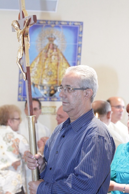 Justo Luis Rodriguez of the Diocese of Pinar del Rio in Cuba carries the processional cross into the Shrine of Our Lady of Charity.