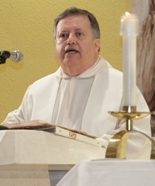 Father Juan Sosa, pastor of St. Joseph Parish on Miami Beach, preaches the homily during the July 14 Mass.