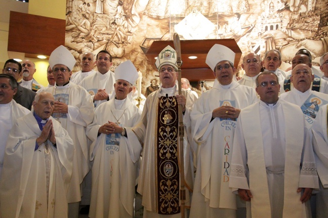 Cuban priests and bishops working on the island and in the U.S. pose for a picture inside the Shrine of Our Lady of Charity after Mass.