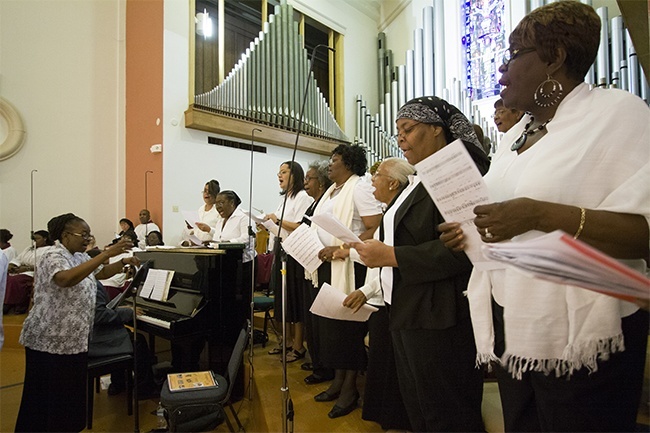 Members of the choir from predominantly black Holy Redeemer and St. Philip Neri parishes sing at the Mass.