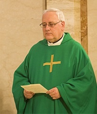 Oblate Missionary Father John Cox, pastor of Holy Redeemer Parish in Liberty City, takes part in the Mass.