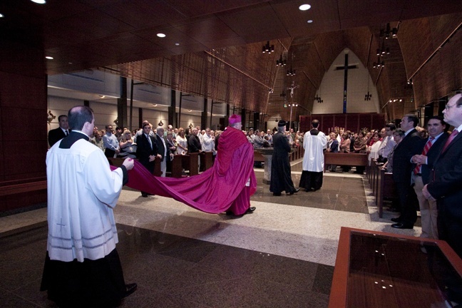 Wearing the cappa magna (large cloak) that once belonged to Miami's first archbishop, Coleman Carroll, Archbishop Thomas Wenski enters Epiphany Church to celebrate Pontifical High Mass in the extraordinary form of the Latin rite.