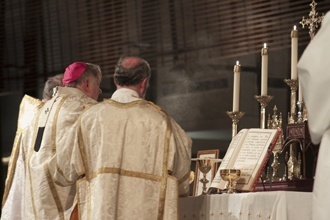 Accompanied by priest-deacons, Archbishop Thomas Wenski incenses the altar before the consecration.
