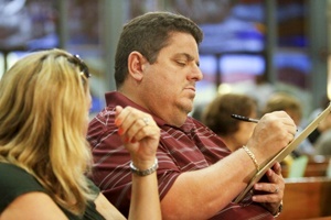 Marcos and Karol Gutierrez of St. Benedict Parish in Hialeah fill out their synod feedback form.