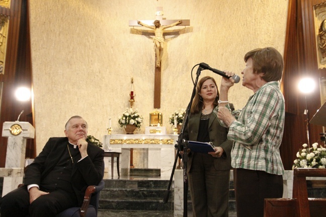 Archbishop Thomas Wenski listens as participants at the Immaculate Conception listening session in Spanish make their views known. Moderator Lucia Baez Luzondo, director of the Family Life Office, stands in the center.
