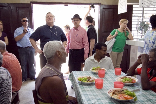 Archbishop Thomas Wenski, now chaplain of the Cuban Association of the Order of Malta, and Father Daniel Kubala, pastor of St. Thomas the Apostle in Miami, are seen here during a February 2011 visit to the Church of Nuestra Senora del Rosario in Palma Soriano, home to one of the centers for the elderly supported by the Cuban Association of Order of Malta.