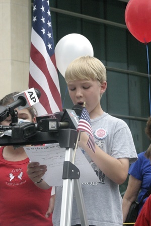 Luke Getchell, who just finished the fourth grade at St. Theresa School in Coral Gables, reads the First Amendment to the U.S. constitution at the start of the Miami rally.
