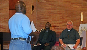 A parishioner expresses his joys, concerns and dreams for the Church in South Florida to Oblate Missionary Father John Cox, right, pastor of Holy Redeemer Parish in Liberty City, and Father Chanel Jeanty, archdiocesan chancellor for canonical affairs and pastor of St. Philip Neri in Miami Gardens.