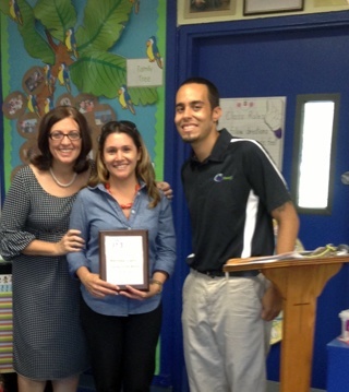Blessed Trinity principal Maria Teresa Perez, 97.3 FM the Coast Teacher of the Month Melinda Usallan and a representative from the radio station pose after presenting Usallan with her award.