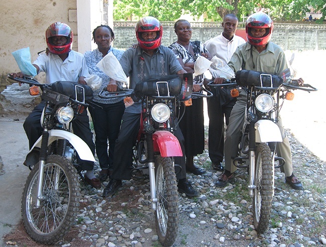 Supervisors of Catholic schools in the Diocese of Port-de-Paix, Miami's sister diocese, show off the motorcycles purchased through the generosity of a Miami donor. Marie Louise Sylvestre, director of the diocese's Department of Schools, is standing third from right in this picture.