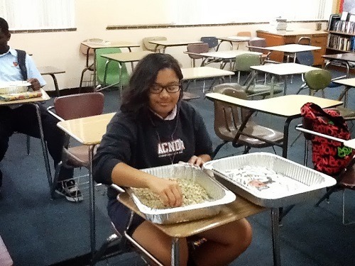 Diversity Action Team member Elizabeth Pineer helps to sort good from bad coffee beans as part of the group's Brewing Hope for Haiti project.