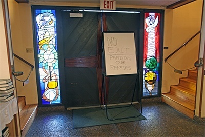The front entrance to St. Maurice Church is closed off because the awning outside is sagging.