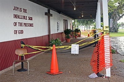 Rotted wood columns hold up the awning above the entrance to St. Maurice Church. The parish cannot afford to make the extensive repairs that would make the building safe once more.
