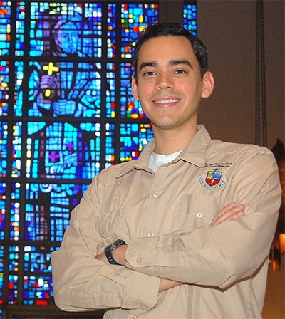 Alvaro Vega poses near a stained glass window at St. Vincent de Paul Seminary where he is studying for the priesthood in the Archdiocese of Miami.