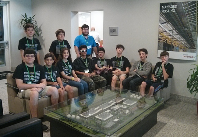 Msgr. Pace High School’s Geek Week participants sit for a photo while on tour at NAP of the Americas. Pictured: (Sitting, from left) camp attendees Gabriel Ponce, Eduardo Gabriel, Alexandra Perez, Antonio D’Argenzio, Francisco Pinagel, Andrew Sanchez, Alexander Moore, and Alexander Florin. (Standing, from left) camp attendees Noah Florin, Joshua Dubon, and Pace alumnus and chaperone Marcos Mirabent.